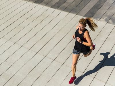 Young woman jogging outdoors for fitness and mental well-being.