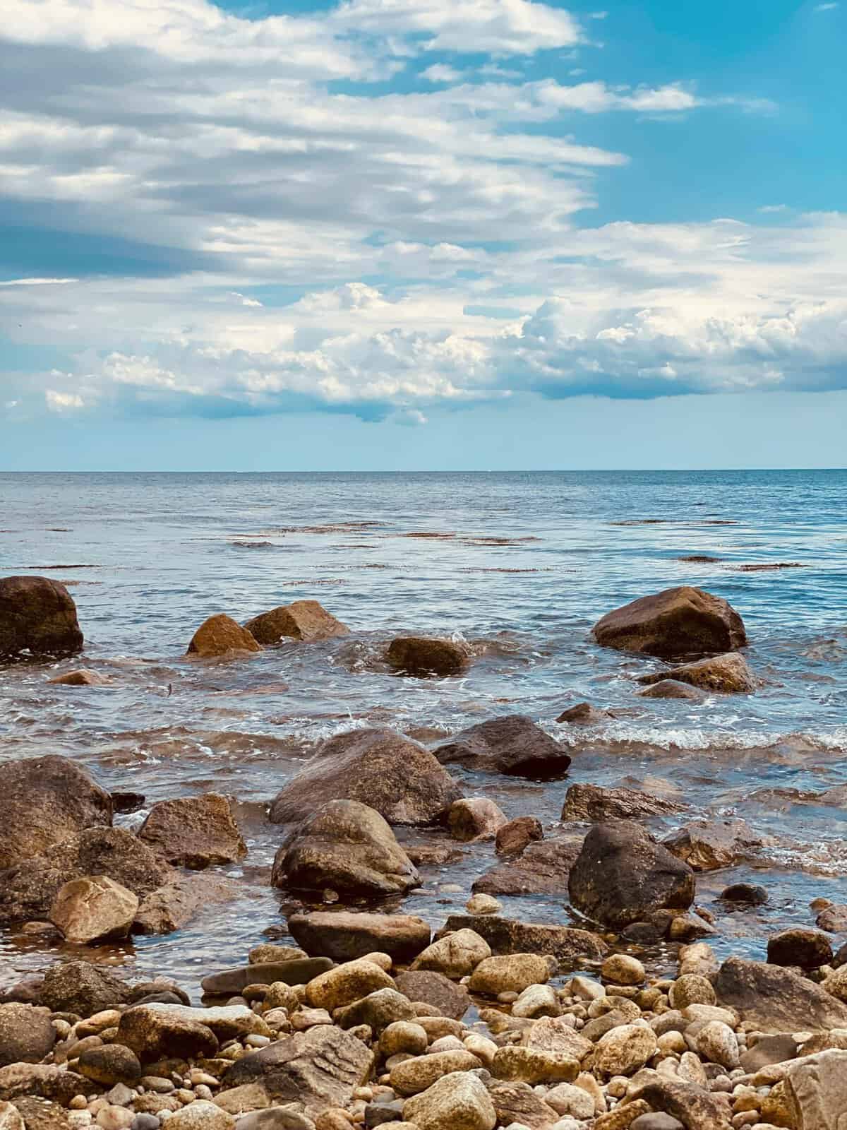 Rocky shoreline under cloudy sky